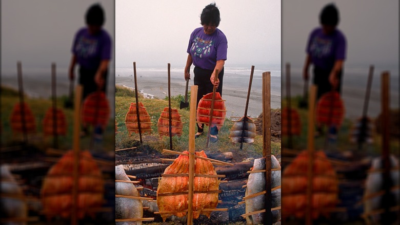 indigenous woman preparing salmon