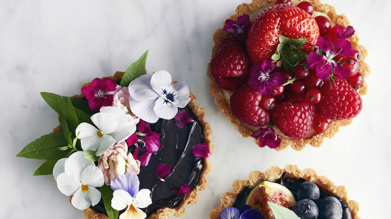 An assortment of different fruit and chocolate tarts