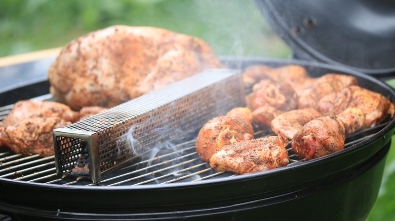 meats cooking on a grill smoker