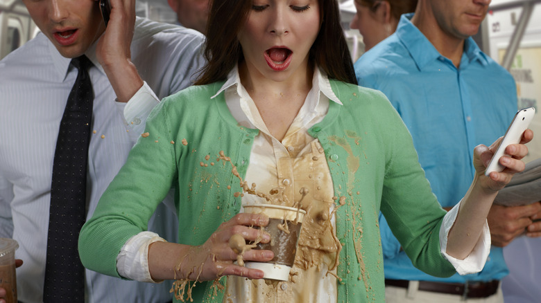 A person looking annoyed wearing a coffee stained white shirt