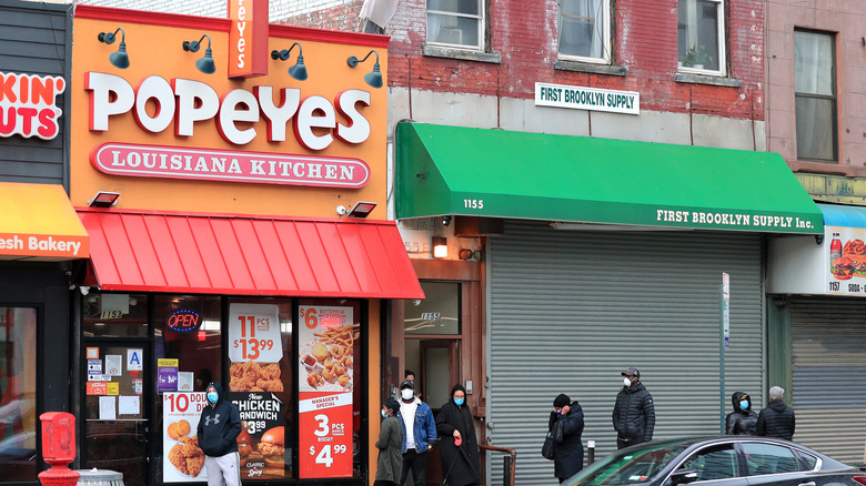 Customers outside a Popeyes restaurant