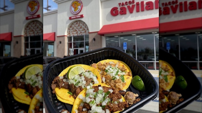 Tacos held up in front of Tacos Gavilan restaurant