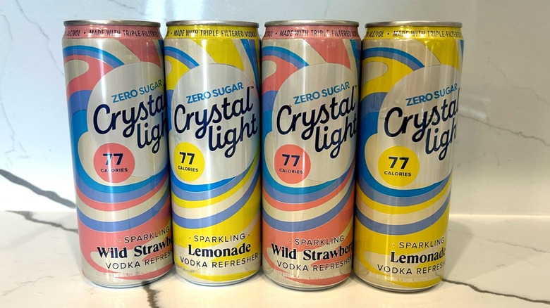 Four cans of Crystal Light Vodka Refreshers lined up on a counter