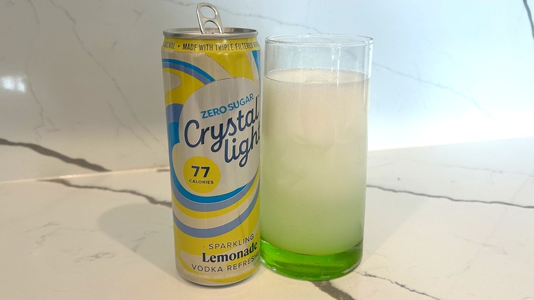 Crystal Light Lemonade Vodka Refresher in a glass next to the can