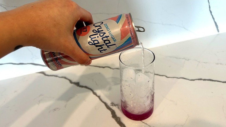 Pouring Crystal Light Wild Strawberry Vodka Refresher into a glass