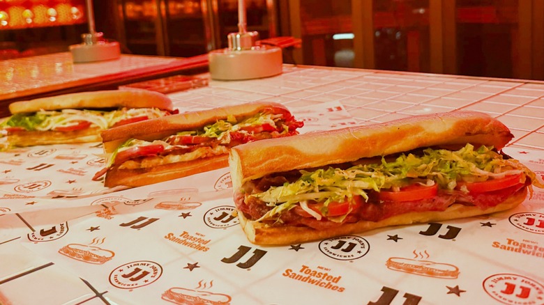 Jimmy John's new toasted footlong sandwiches on a white tile counter