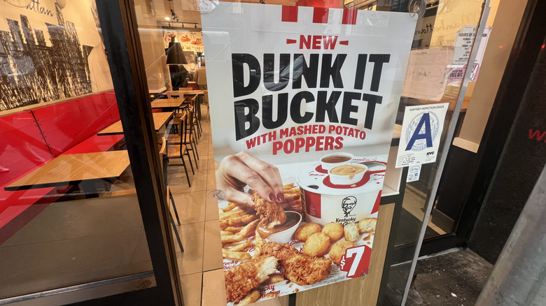 A Dunk It Bucket sign in a KFC window