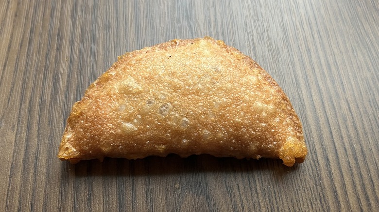 Taco Bell's Caramel Apple Empanada resting on a table