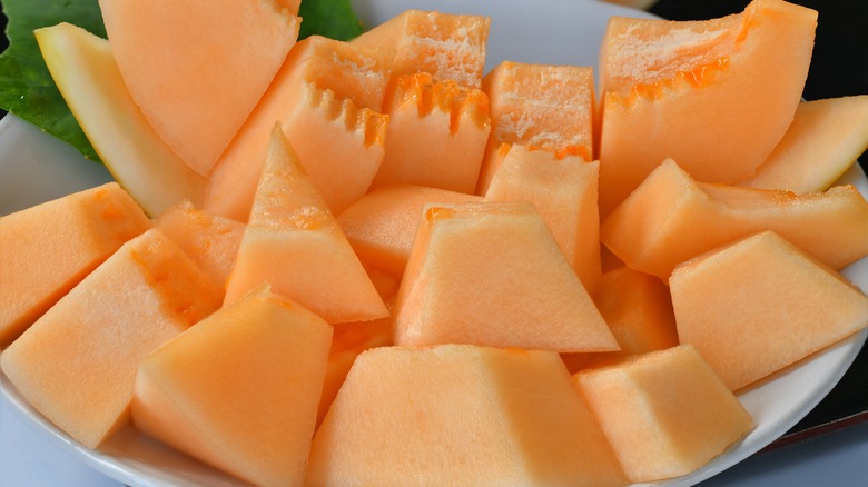 cut pieces of cantaloupe in white bowl