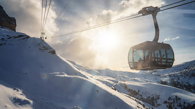 Gondola on cable wire over snowy mountain