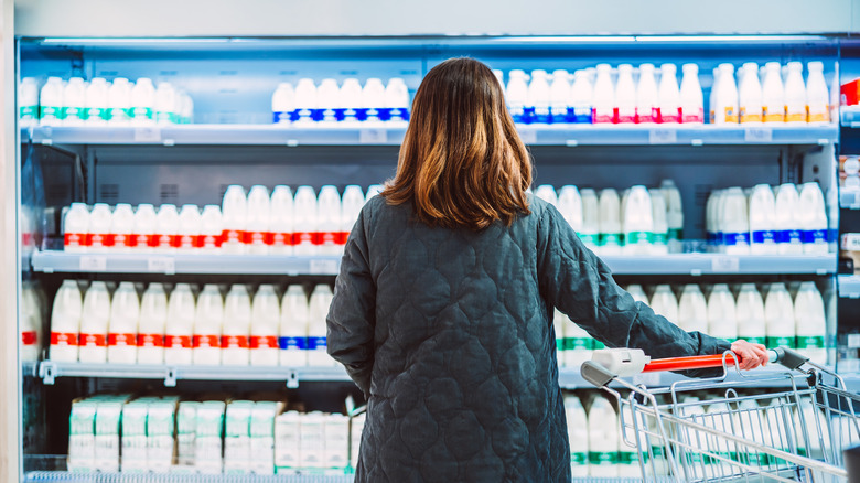 woman staring at milk selection