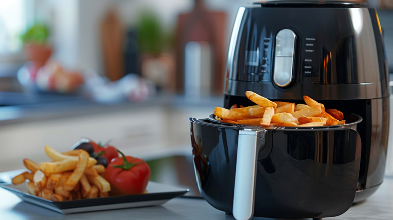 fries in air fryer basket on counter