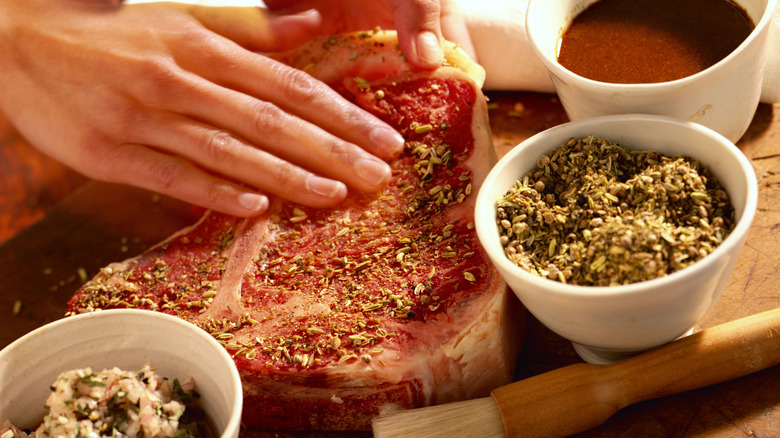 seasonings rubbed into raw steak