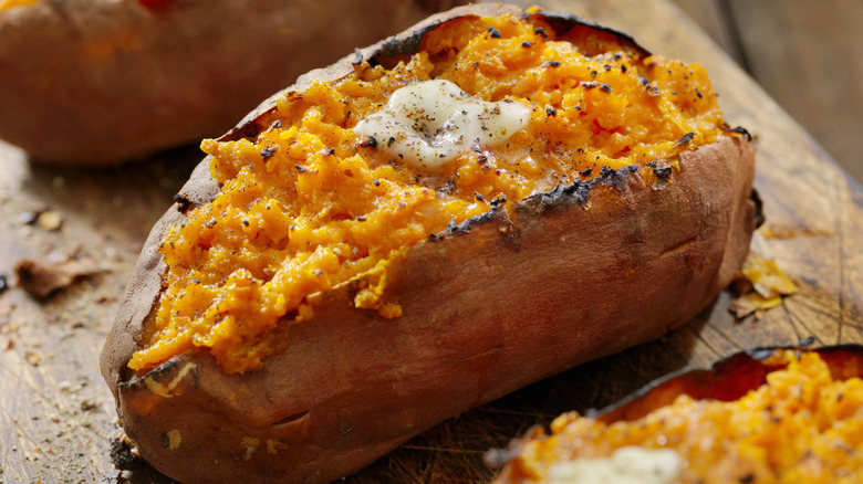 A roasted sweet potato topped with melting butter