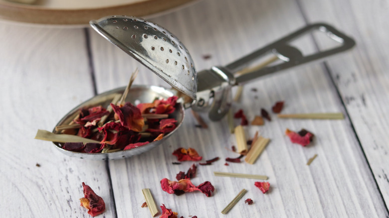 Loose leaf tea in a metal strainer.