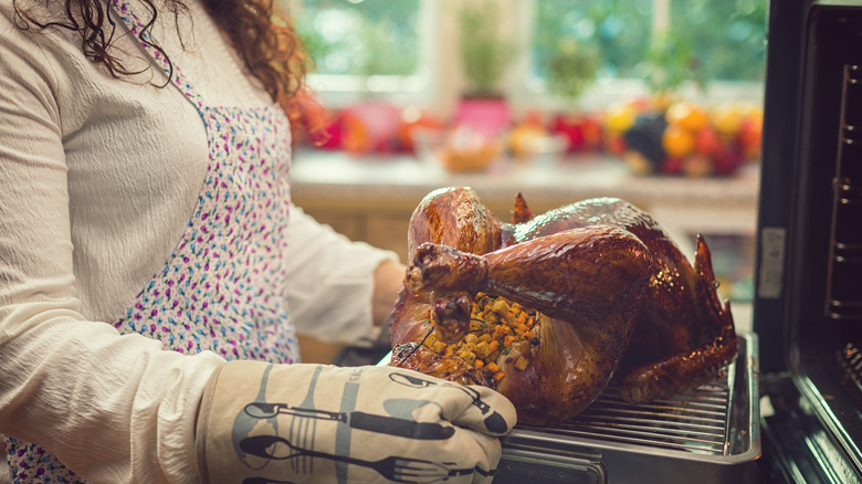 A cook preparing a thanksgiving turkey.