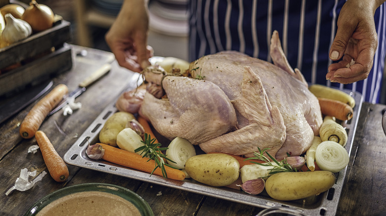 A cook preparing a Thanksgiving turkey.