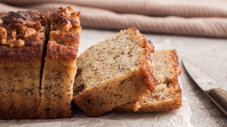 A closeup of banana bread with walnuts on top