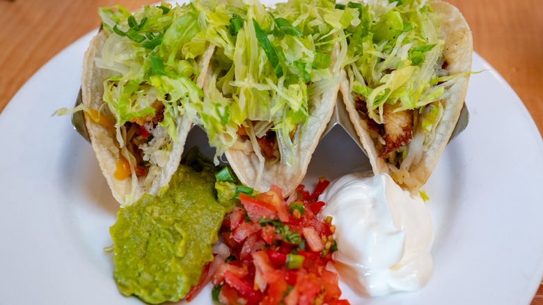 Tacos with guacamole, salsa, and sour cream