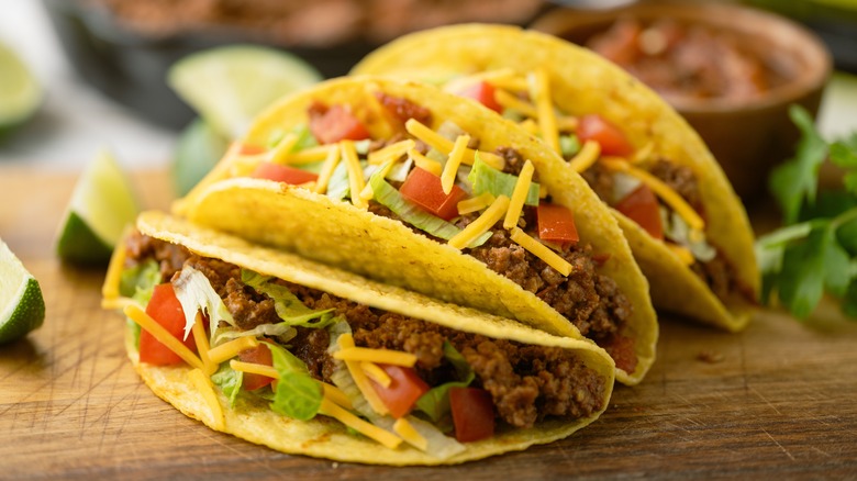 Three beef tacos with cheese