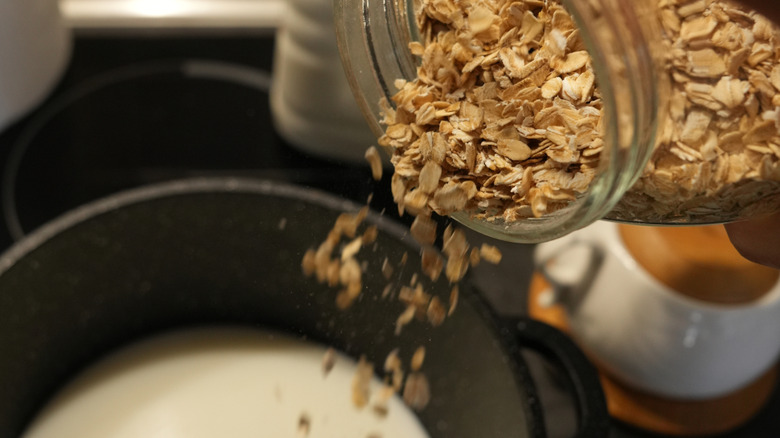 Pouring oats in cooking liquid