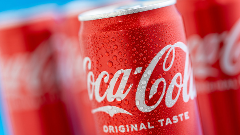 A close up of a can of Coca-Cola, beaded with condensation