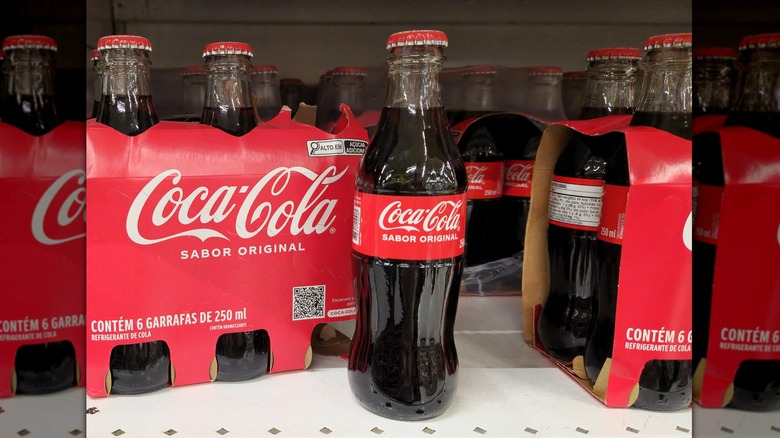 Coca-Cola cases and bottles on a table.