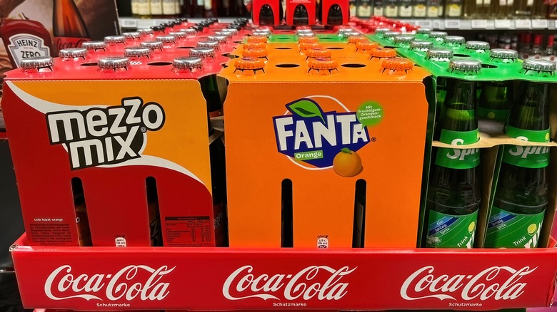 Mezzo Mix, Fanta, and Sprite cases next to one another