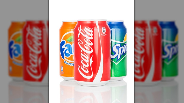 A trio of Coca-Cola, Fanta, and Sprite cans