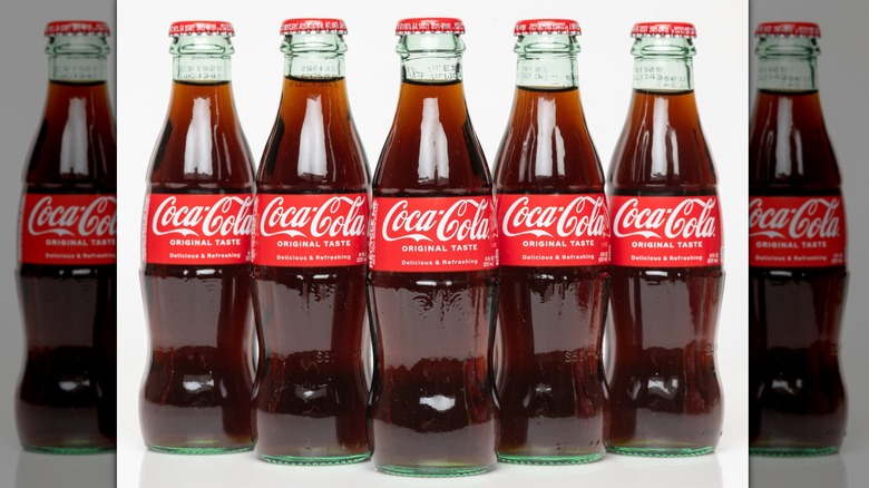 Five full Coca-Colas packaged in small glass bottles