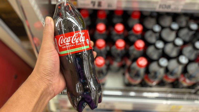 Person holding a Japanese bottle of Coca-Cola