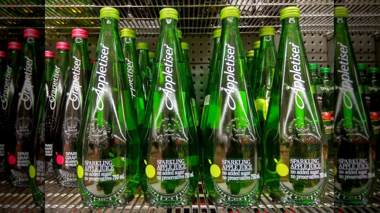 Many bottles of Appletiser on a shelf