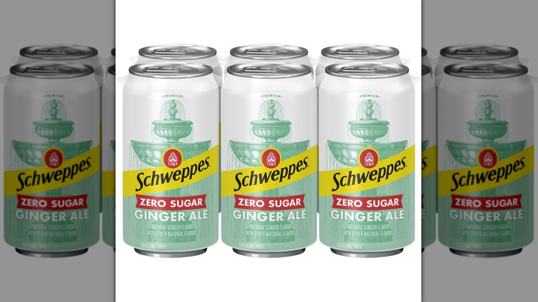 Six cans of Schweppes Zero Sugar Ginger Ale on a white background