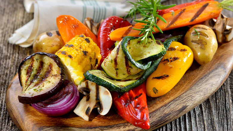 A variety of grilled vegetables on a wooden board