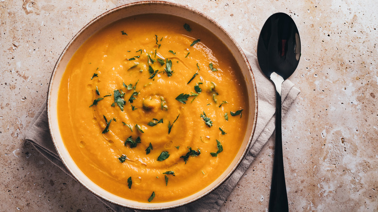 A bowl of soup sitting on a table.