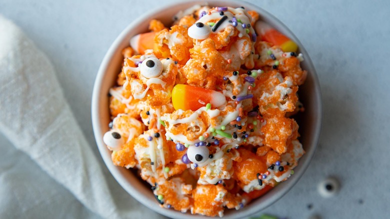 orange popcorn with sprinkles and googly eyes