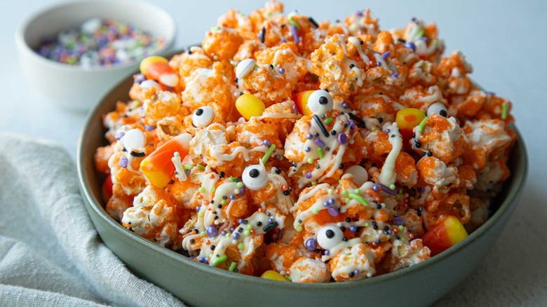 orange popcorn with sprinkles and googly eyes