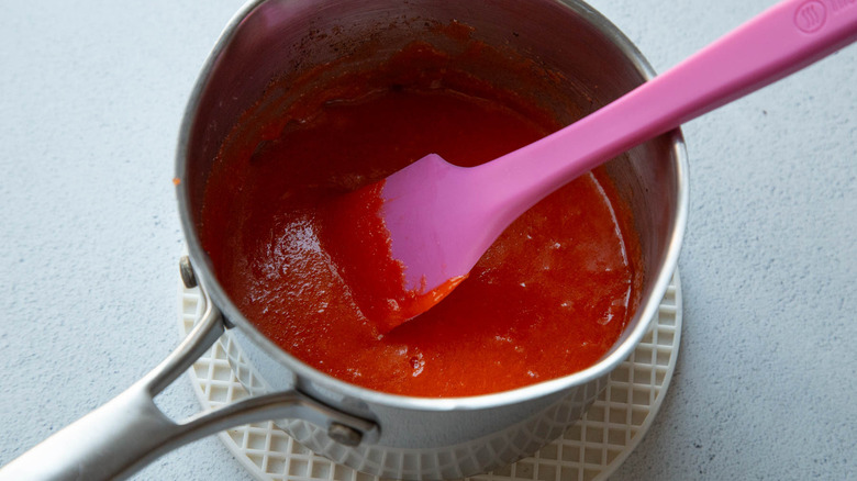 orange gelatin mixture in a saucepan