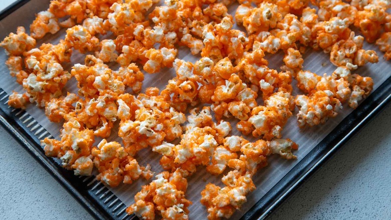 orange popcorn on a sheet pan