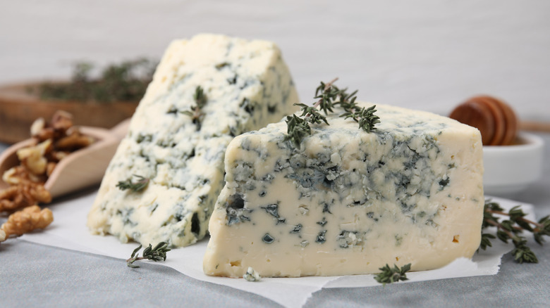 Two chunks of blue cheese sprinkled with thyme