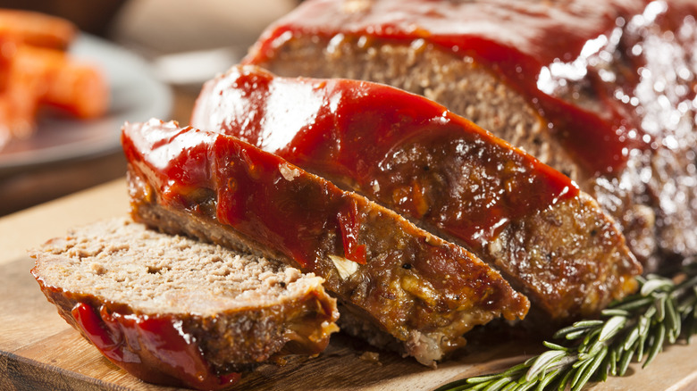 Sliced cooked meatloaf glazed with ketchup