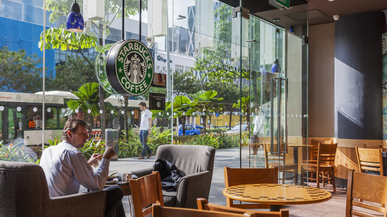 Starbucks with glass walls looks out on greenery