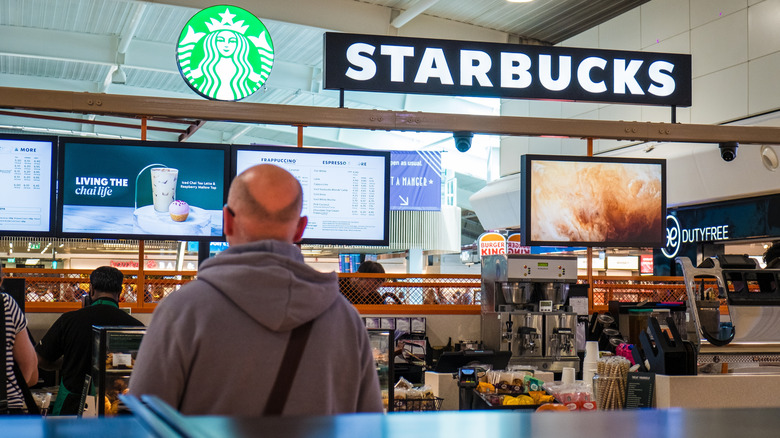 shot of an airport starbucks with signage and menu