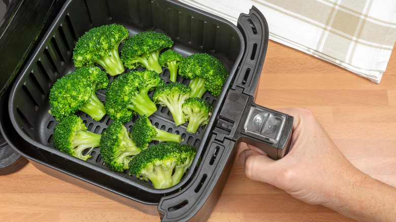 Broccoli florettes in an air fryer basket