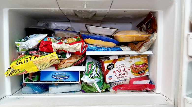 A freezer filled with frozen food.