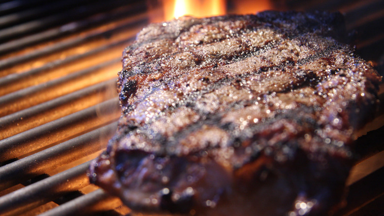 ribeye steak over flames