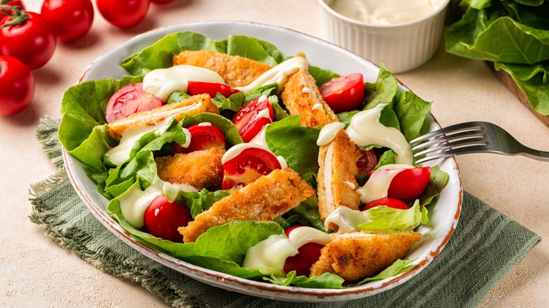 fried chicken in a simple green salad