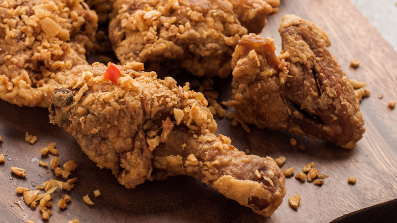 pieces of fried chicken on wooden board