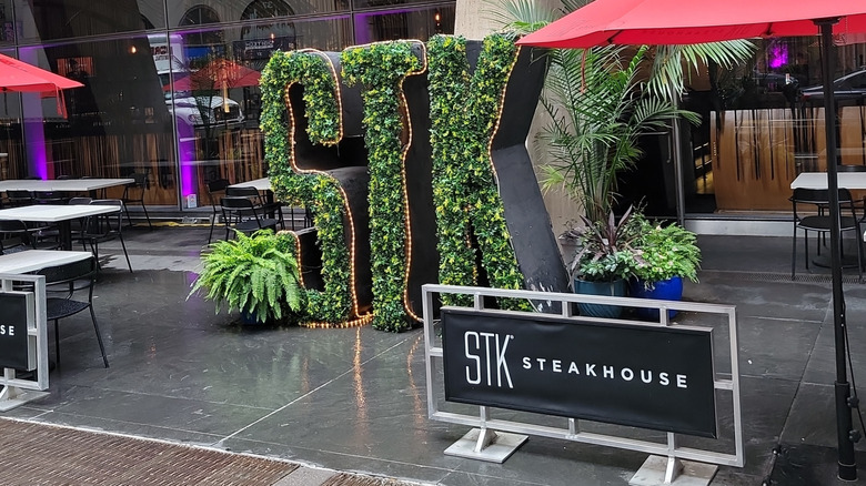 STK Steakhouse with STK in hedges and tables