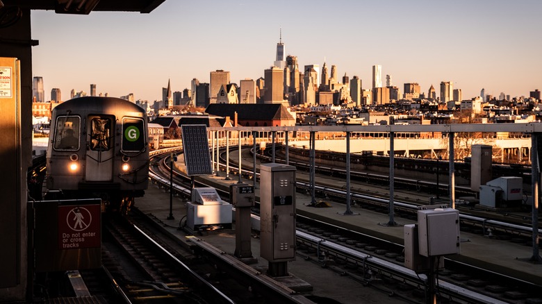 Train approaching station with NYC skyline